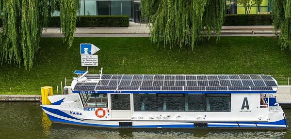 Wolfsburg, Lower-Saxony, Germany, July 21., 2018: Passenger ship Aluna at the pier on the Mittelland Canal in front of the Autostadt, roof with solar cells for environmentally friendly energy supply