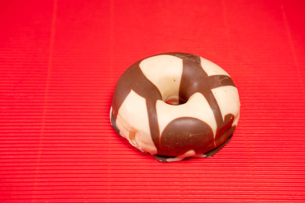 decorated doughnut on a red background. Sweet and colourful doughnuts
