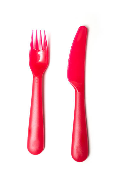 istock red baby plastic fork and knife on white background 1084177182