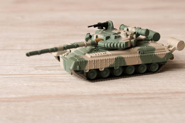 istock Toy model of the Soviet tank on a wooden table. 1084179452