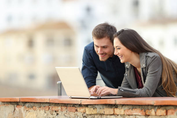 istock Happy couple searching online content on a laptop 1084179620