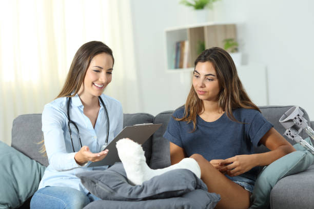 istock Happy doctor and patient talking at home 1084179674