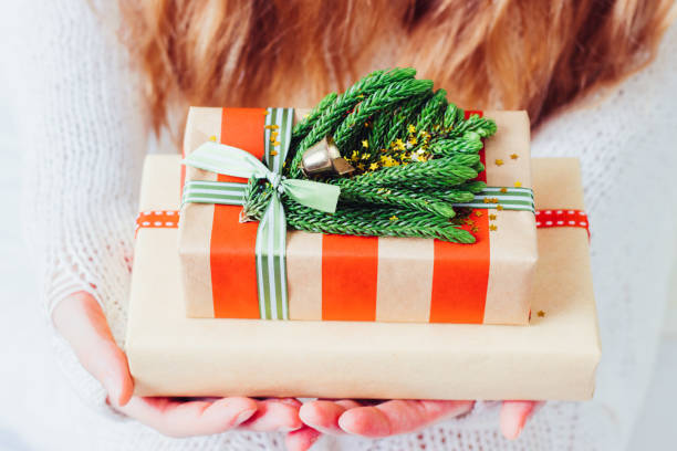 istock Woman's hands hold christmas or new year gift box. 1084180602