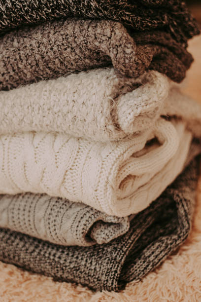istock knitted sweaters on a soft peach carpet close-up 1084181532
