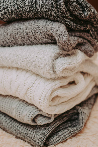 istock knitted sweaters on a soft peach carpet close-up 1084181732