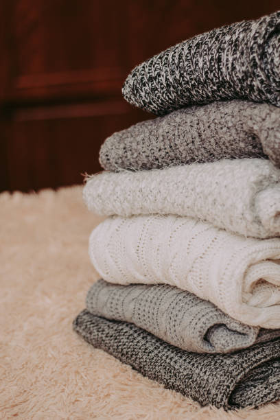 istock knitted sweaters on a soft peach carpet close-up 1084183126