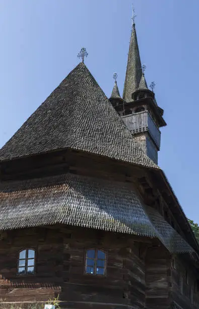 Photo of Beautiful old medieval small wooden church in Budesti, Romania.