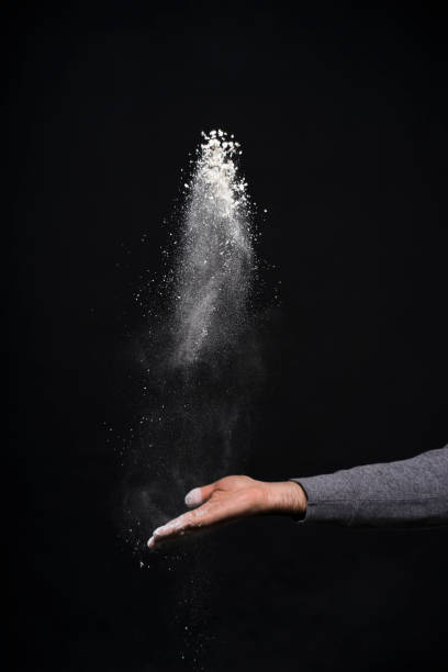 istock Studio shot of a man's hand with flour against black background 1084187748