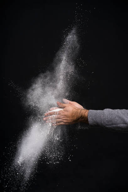 istock Studio shot of a man's hand with flour against black background 1084187750