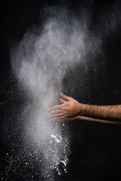 istock Studio shot of a man's hand with flour against black background 1084187752