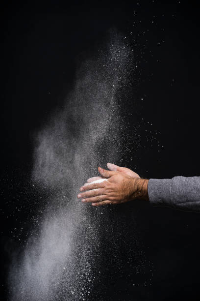 istock Studio shot of a man's hand with flour against black background 1084187766