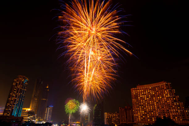 istock Beautiful firework display for celebration happy new year and merry christmas with  Twilight night and firework lighting in bangkok cityscape background, Thailand. 1084189930