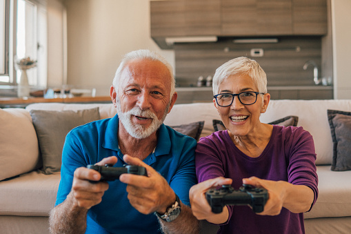 Happy man playing video games with his wife
