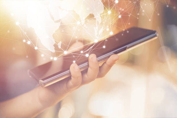 istock hand holding smartphone with global network, business and technology concept. 1084192760