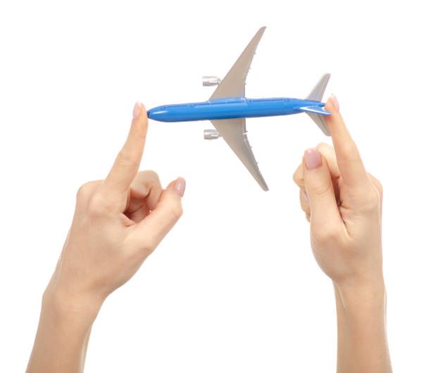istock Miniature airplane in hand travel 1084192924
