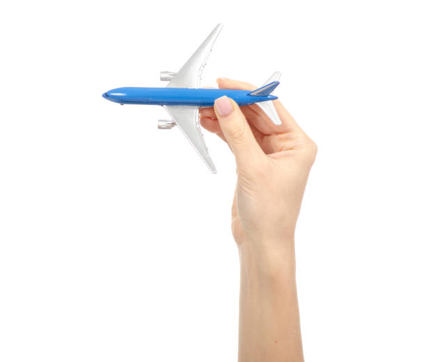 istock Miniature airplane in hand travel 1084192936