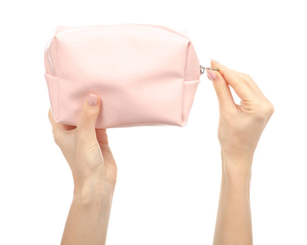 istock Pink cosmetic bag in hand beauty 1084192978