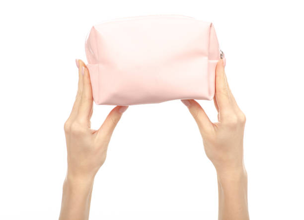 istock Pink cosmetic bag in hand beauty 1084193224