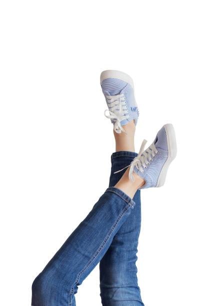istock Woman legs in a blue jeans on white background isolated 1084195764