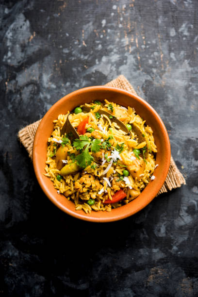 Masala Rice or masale bhat - is a spicy vegetable fried rice / biryani or Pulav usually made during wedding occassions in maharashtra, India Masala Rice or masale bhat - is a spicy vegetable fried rice / biryani or Pulav usually made during wedding occassions in maharashtra, India tomato rice stock pictures, royalty-free photos & images