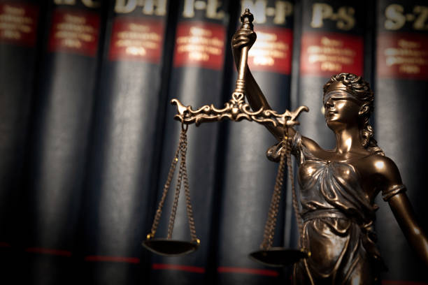 istock Statue of justice on books background 1084198154