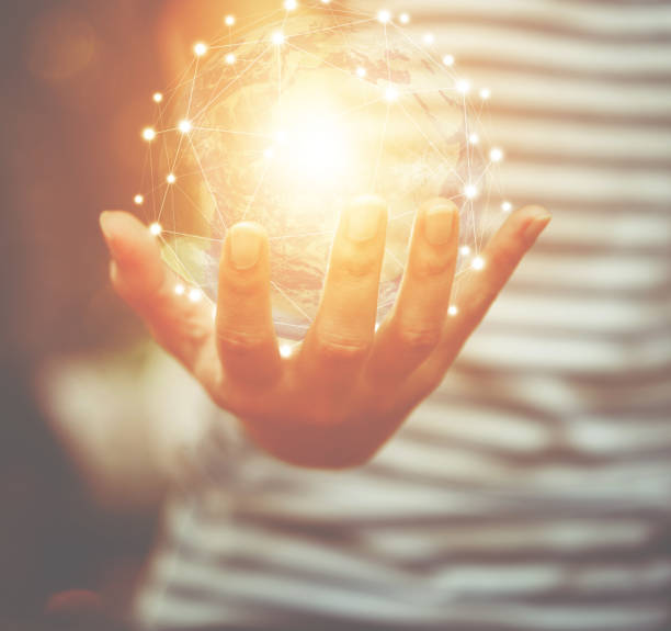 istock Hand holding flying earth network global connection concept, Elements of this image furnished by NASA 1084198354