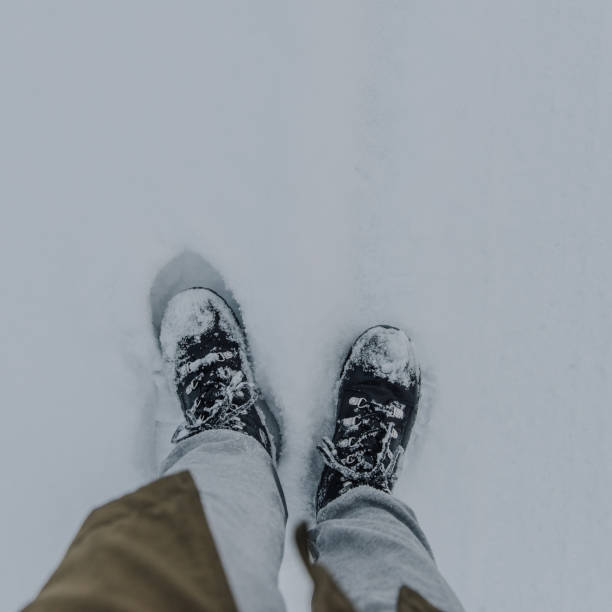 istock Winter boots in snowy landscape 1084199156