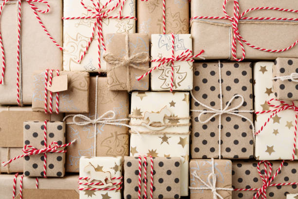 istock Christmas background with gift boxes wrapped in brown kraft paper flat lay. 1084205282