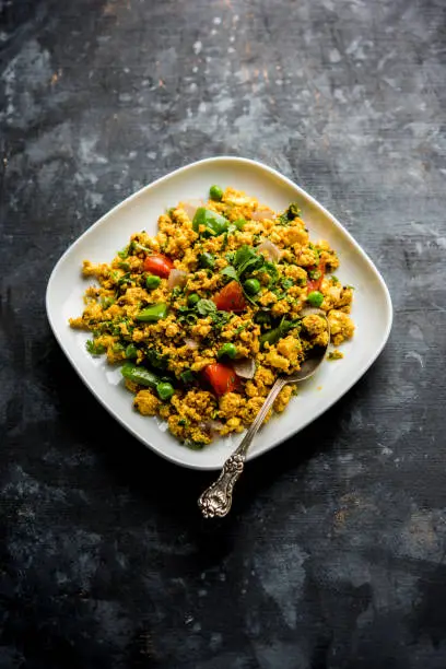 Paneer Bhurji, mildly spiced cottage cheese scramble and served with roti or laccha paratha, selective focus