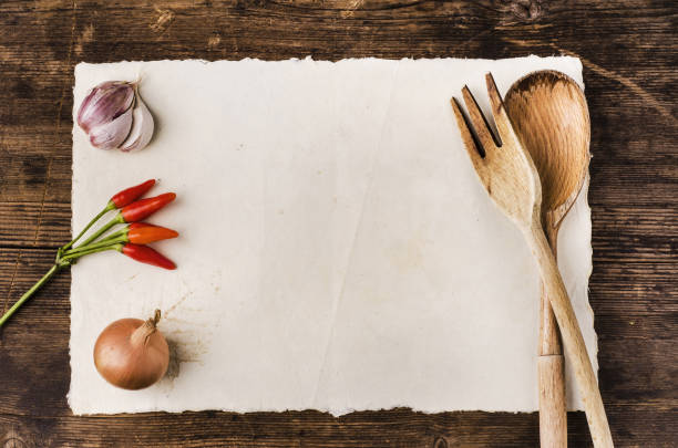 still life. Top view of a white parchment with space for text, wooden utensils and ingredients. Cookbook