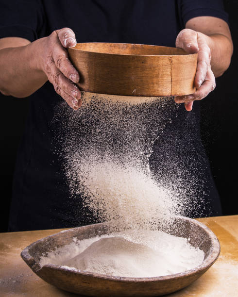 istock sift the flour for the homemade dough 1084210368