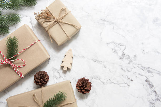 istock Christmas background with decorations and gift boxes on white marble. 1084211386