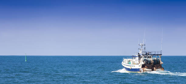 istock Homecoming: Tired fishermans ship approaching after a hard day. 1084212842