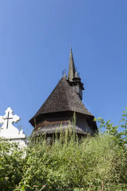 Photo of Beautiful old medieval small wooden church in Budesti, Romania.