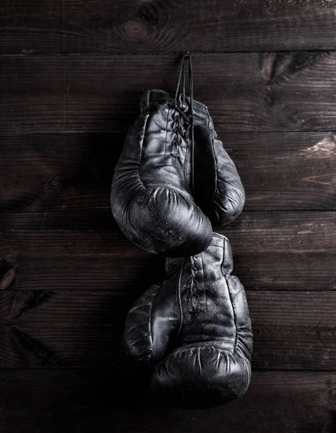 istock black leather boxing gloves hanging on a nail 1084215980