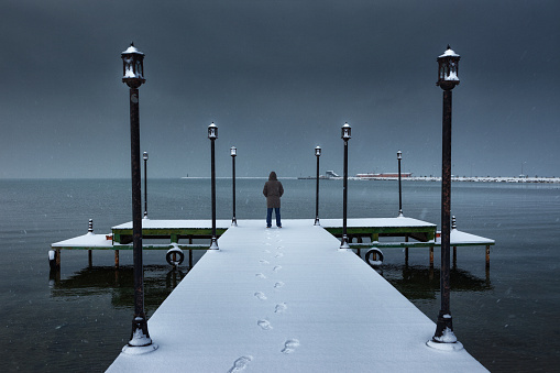 A man standing on a pier near Lake Van, Turkey.