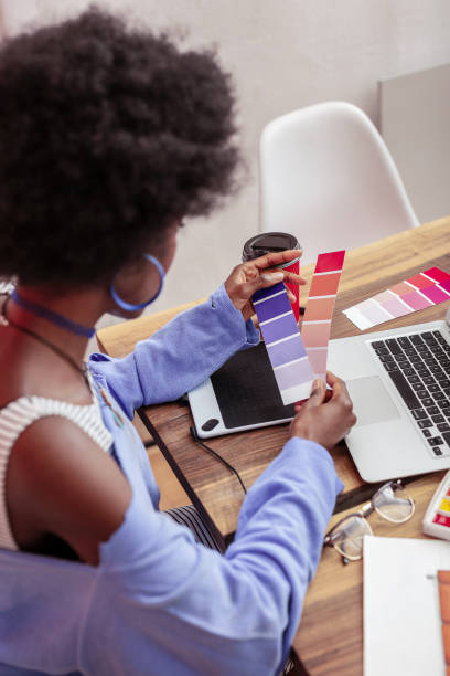 istock Young fashion designer holding color palettes while working 1084217820