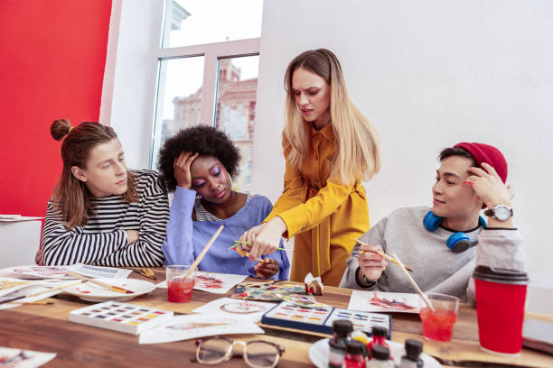 istock Angry young teacher feeling aggressive talking to her students 1084218014