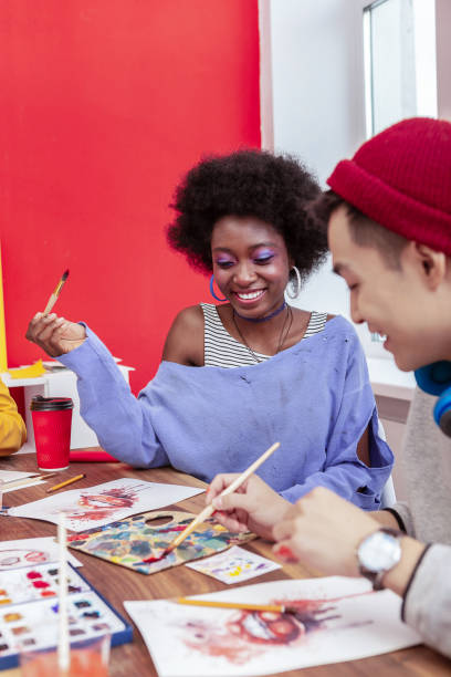 istock Cheerful international student with bright makeup smiling broadly 1084218338