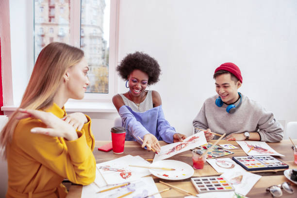 istock African-American art student feeling satisfied with her drawing 1084218406