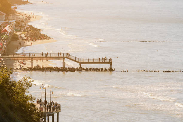 istock People walk on the promenade on a sunny day toned 1084225112