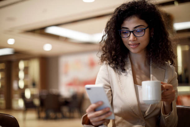 istock Businesswoman using mobile phone at a cafe 1084225378