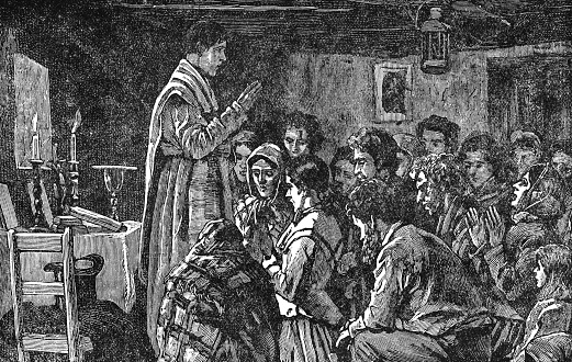 Priest conducting mass in a cabin at a village, rural life in Ireland (circa 19th century). Vintage halftone etching circa late 19th century.
