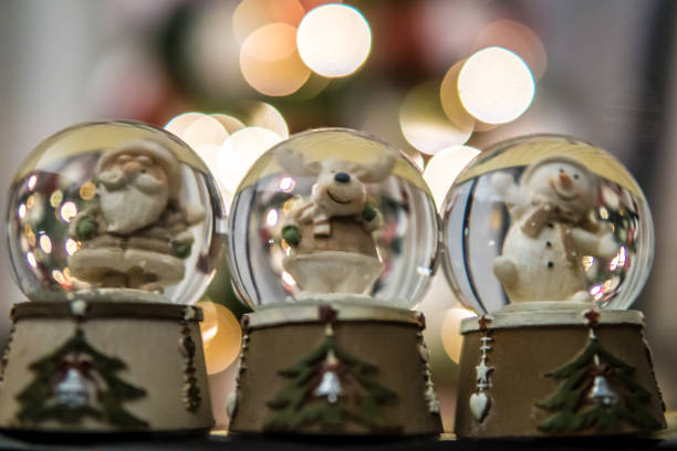 istock Christmas snowy globes holiday decoration blurry lights background 1084229704