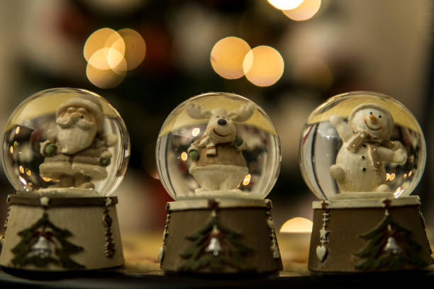 istock Christmas snowy globes holiday decoration blurry lights background 1084229800