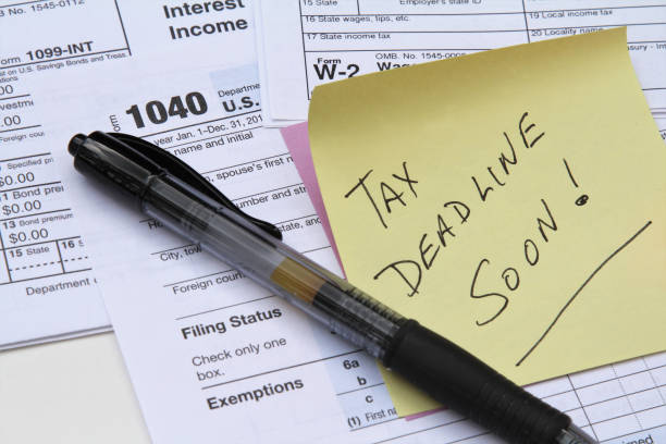 istock Tax return forms and wage statements with note Tax Deadline. 1084231874