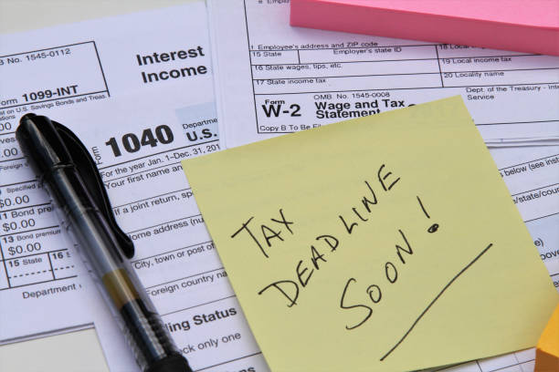 istock Tax return forms and wage statements with note Tax Deadline. 1084231988