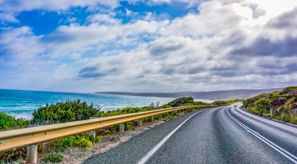 istock Road next to an wonderful ocean, beach and mountains 1084232992