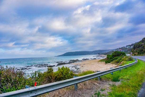istock Road next to an wonderful ocean, beach and mountains 1084233052