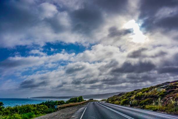 istock Road next to an wonderful ocean, beach and mountains 1084233086